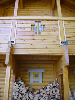 Front of log cabin with timber hatch
